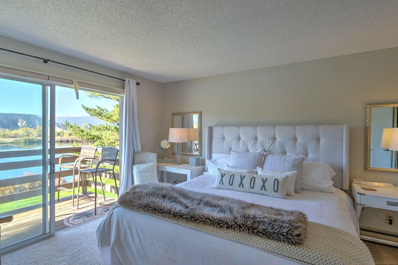 Primary bedroom with king bed, balcony access and pond views