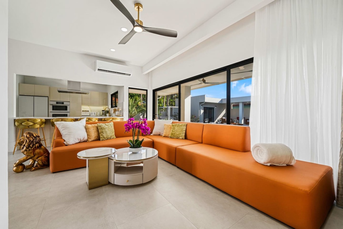 Soak in the bright, tropical atmosphere of this modern living space, complete with vibrant seating and inviting views perfect for unwinding.
