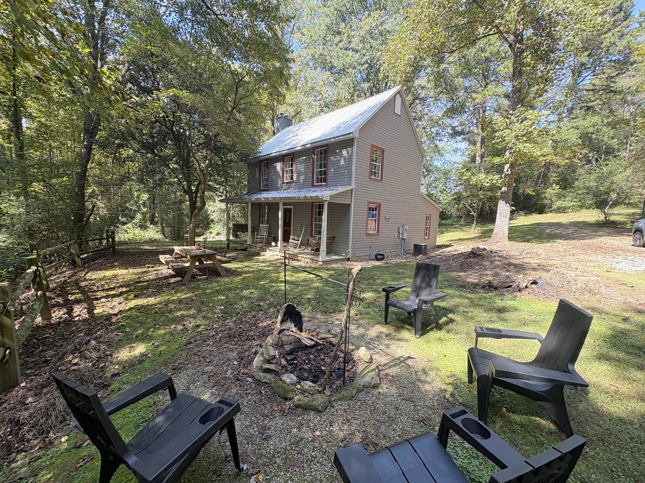 Farmhouse with firepit and Adirondack chairs.jpg
