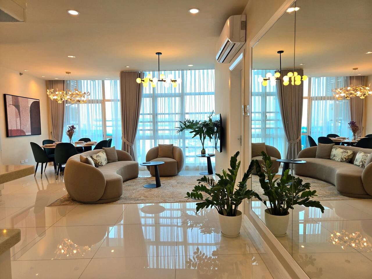 The inviting and spacious living area boasts a beautifully designed dining table that comfortably seats six, perfect for gatherings and memorable meals with family and friends.