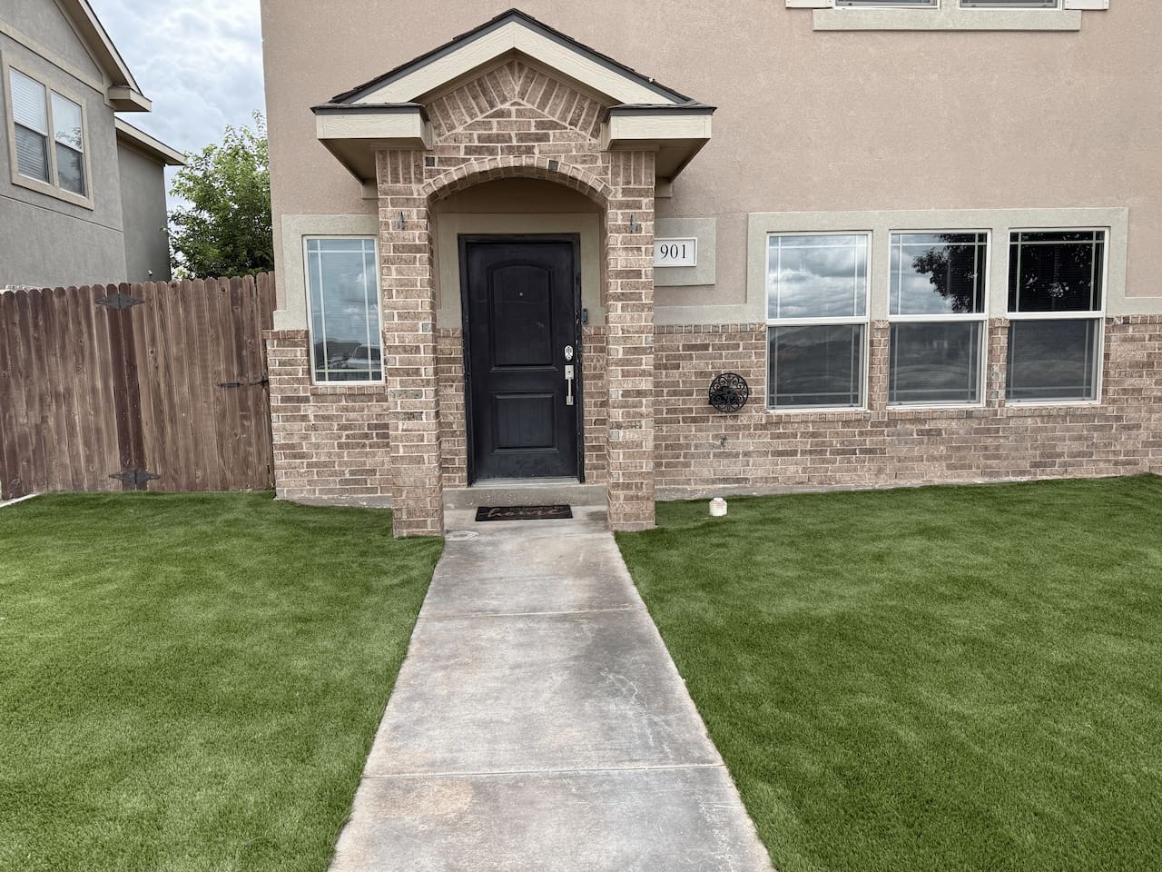 Sunset Retreat — front exterior with fresh turf lawn, 901 Old Course Road, Odessa TX
