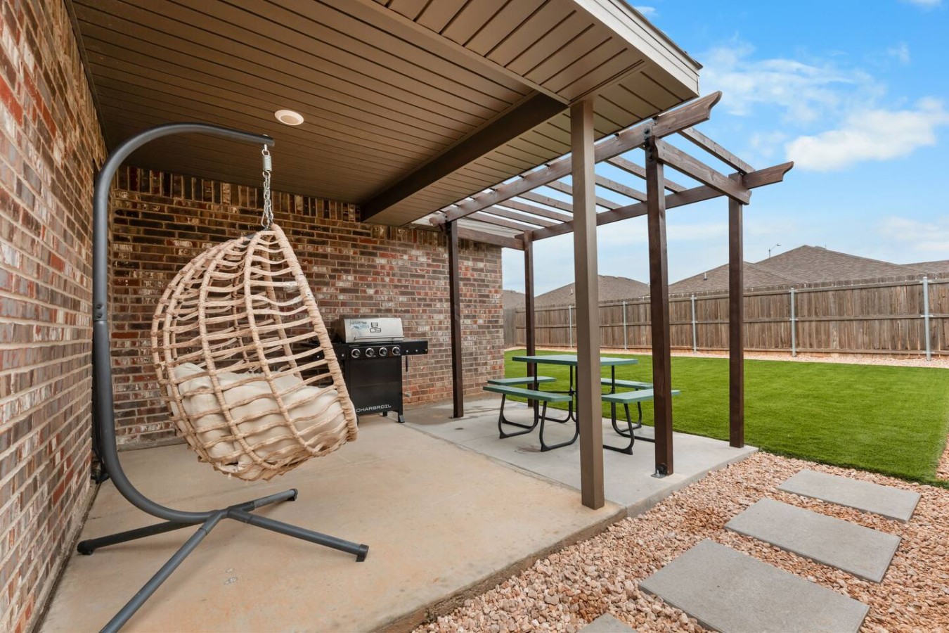 Private covered patio with pergola, gas grill and picnic table at Basin Haven