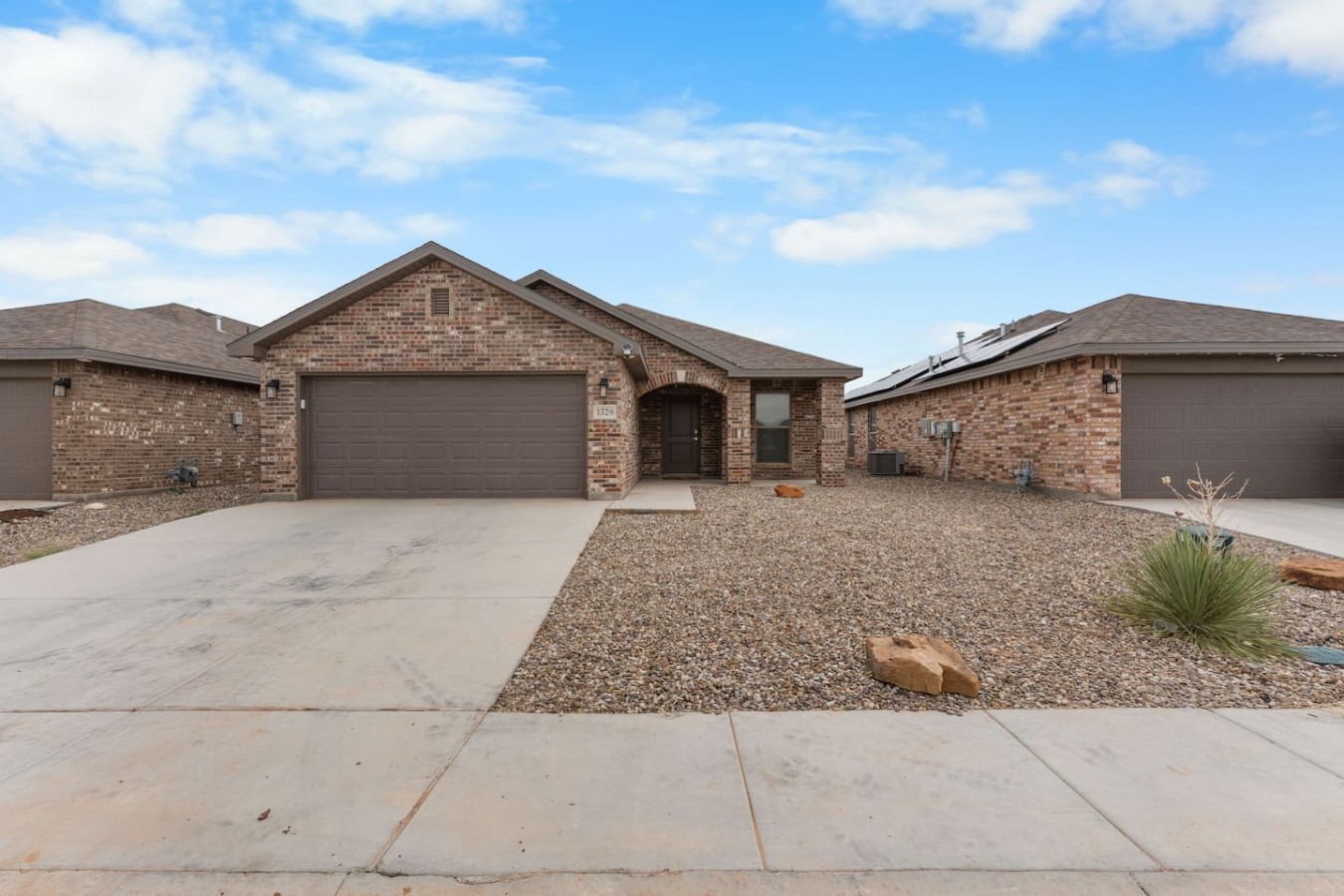 Basin Haven — front exterior with 2-car garage, 1329 E 94th St, Odessa TX