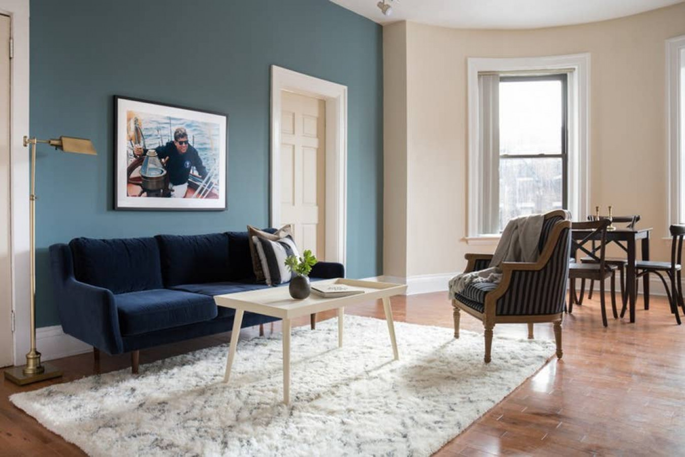 Relax in this beautiful living room with high ceilings!  Portable Air Conditioner installed from May-Oct.