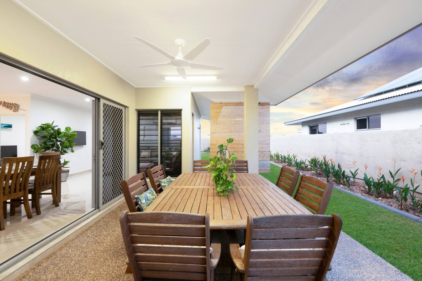 Zenhouse: 4BR Stylish Work/Family Home in Muirhead- Elevate your dining experience with our charming wooden dining table on the balcony, offering a delightful setting for al fresco meals amidst the beauty of nature.