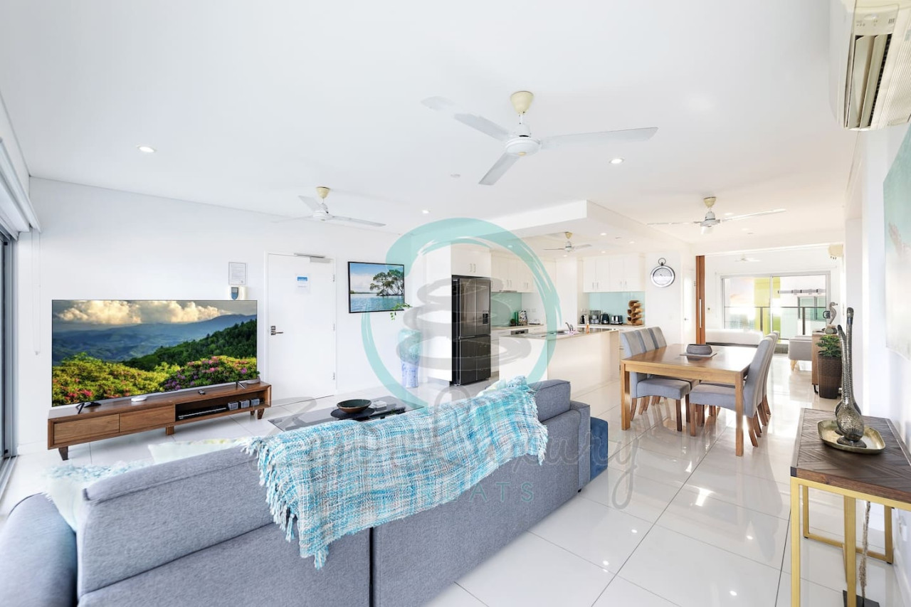 Zen By The Water: Top CBD Location - Pool - Views - Relax and unwind in the cozy ambiance of our living room, featuring a plush sofa and sleek 60" HDTV.