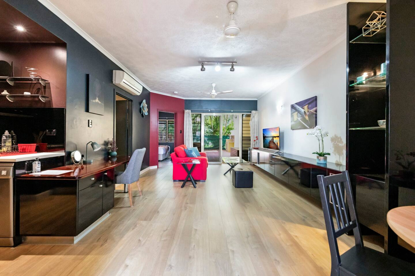 Within the open layout, a designated workspace offers a comfortable environment for remote work or leisurely reading