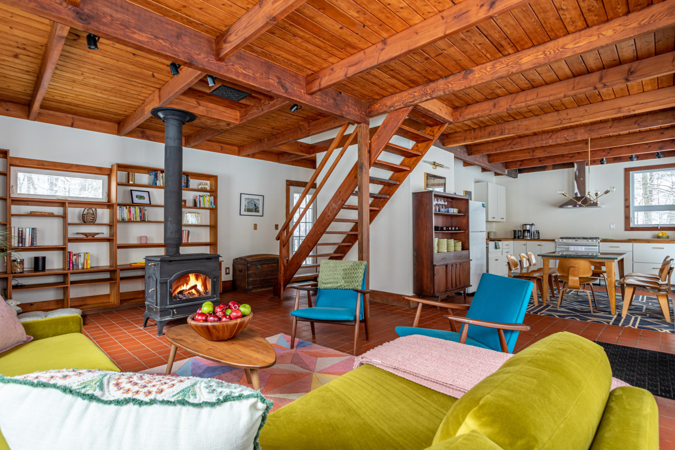 Stunning wood-beamed ceilings and a charming fireplace make this bright, open living space the heart of the home