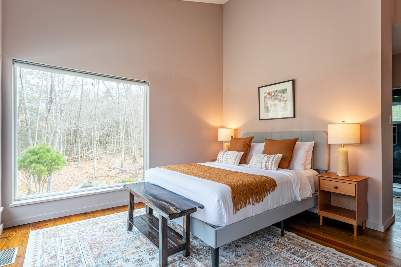 Serene woodland retreat with a king bed, soaring ceilings, and a picture-perfect window bringing nature right to your bedside
