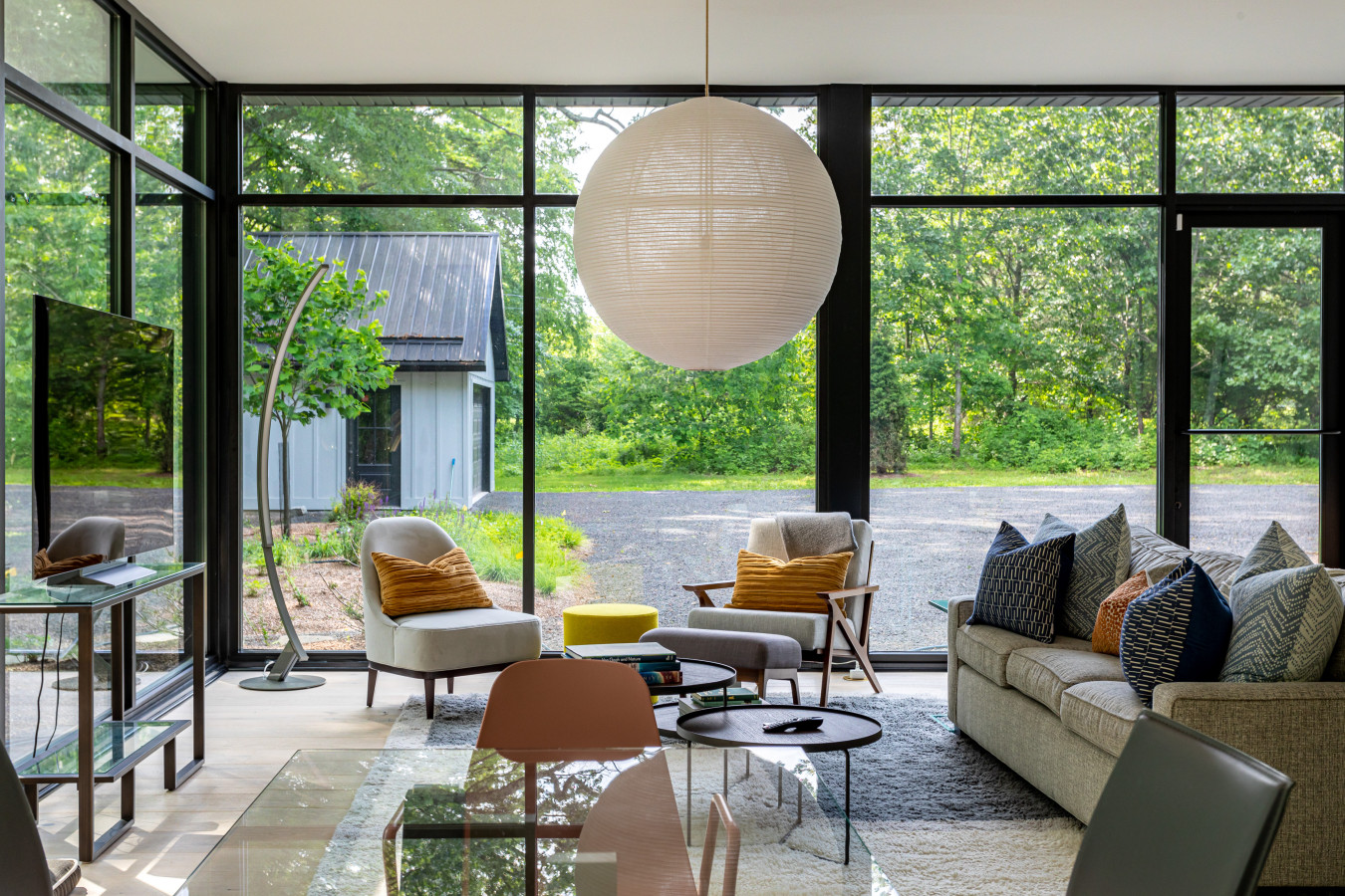 Curl up in the glass living room while overlooking a peaceful garden