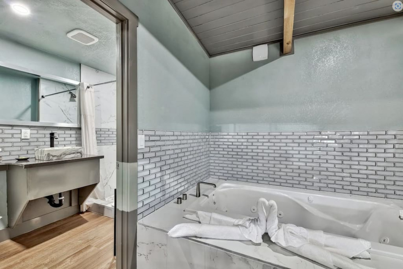 Bath tub across the entry way of the toilet