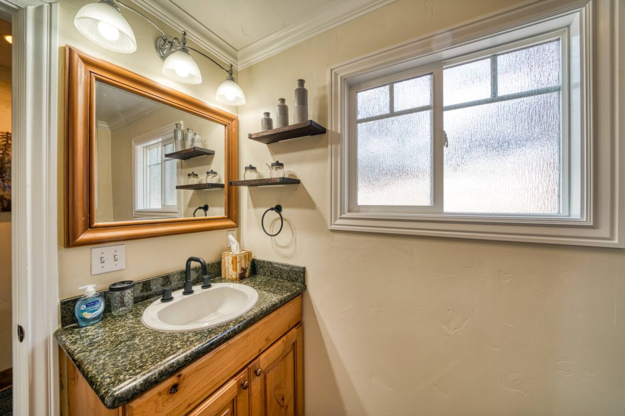 Bathroom with sink and vanity mirror