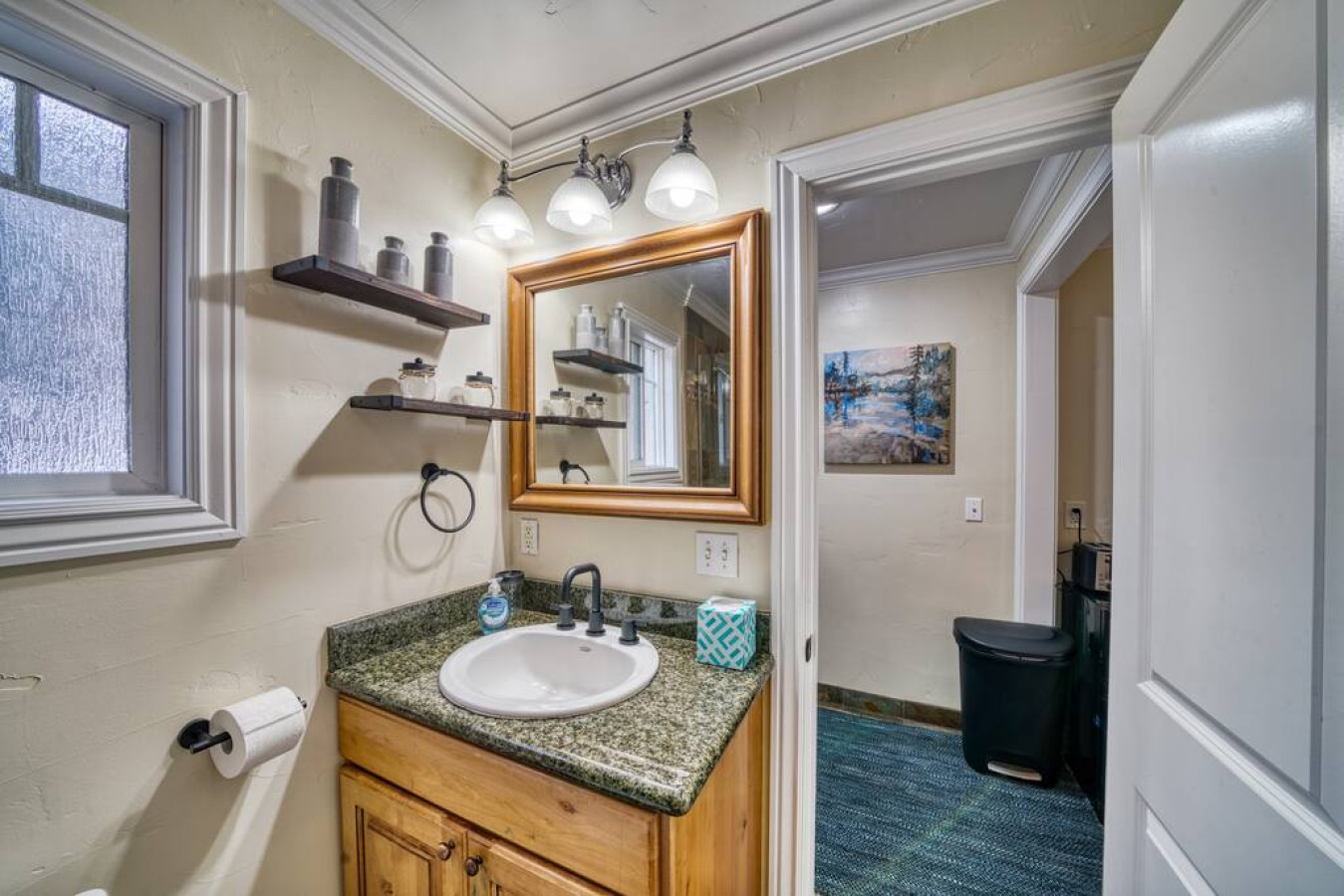 Bathroom with sink and vanity mirror