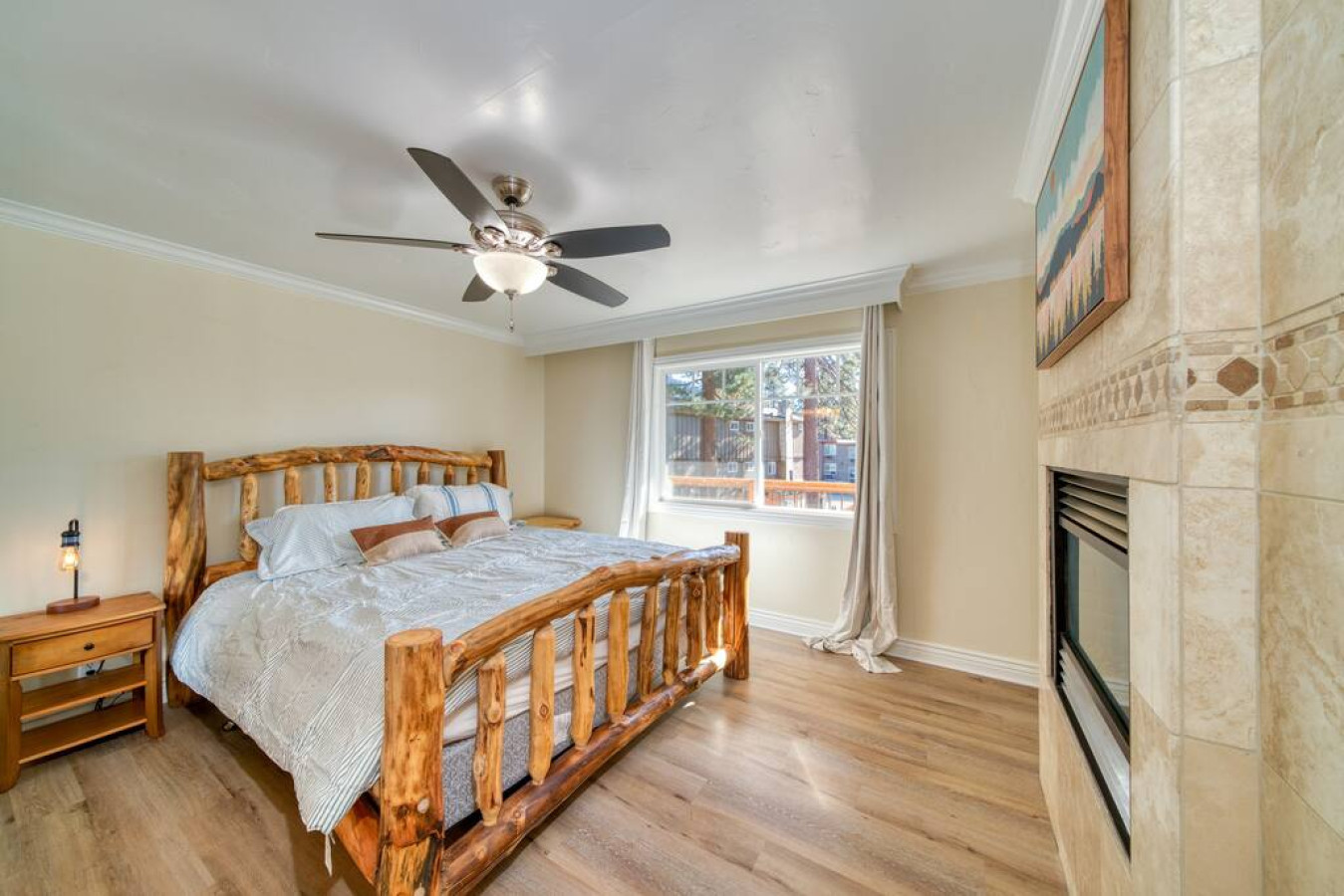 Master bedroom equipped with queen size bed and gas fire place, along with the attached master bathroom.