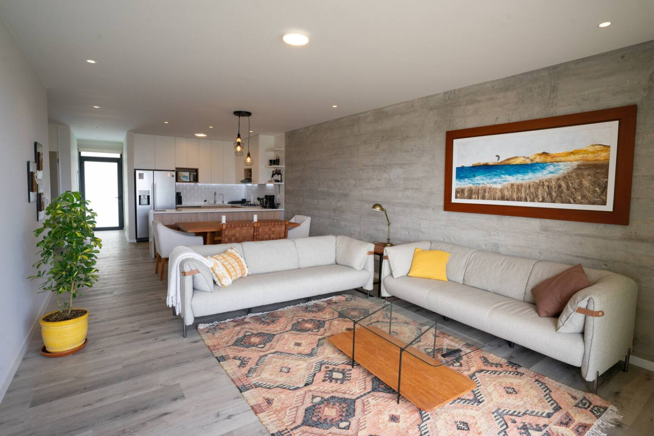 Open living room concept, with kitesurfing painting on wall.