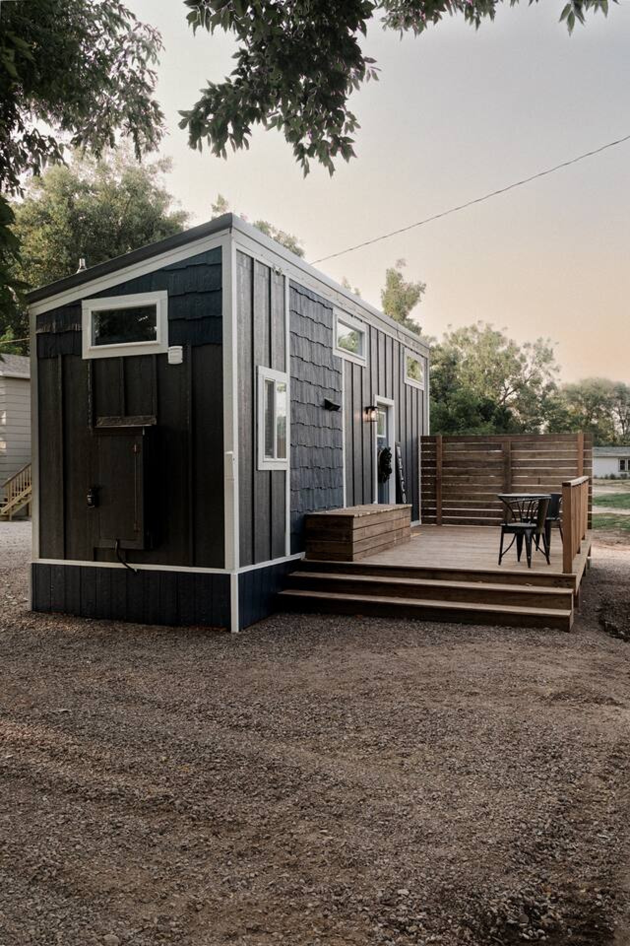 This photo shows our parking area and also the quiet road behind the tiny home. The front of the house and deck face an empty field which is often visited by deer and turkey.