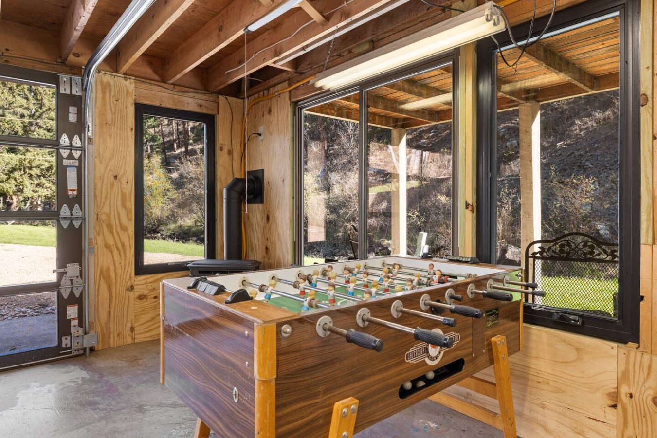 Creekside Retreat | Fireplace + Gameroom — photo 21