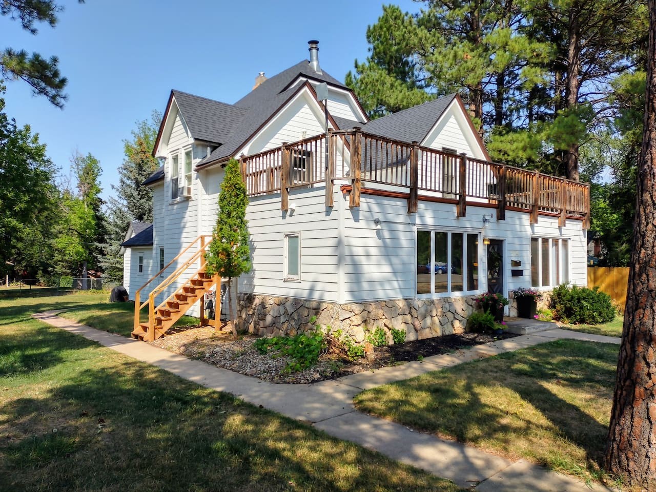 The entrance to the upstairs apartment is on the left side of the house and leads up to the entrance on the upper deck.