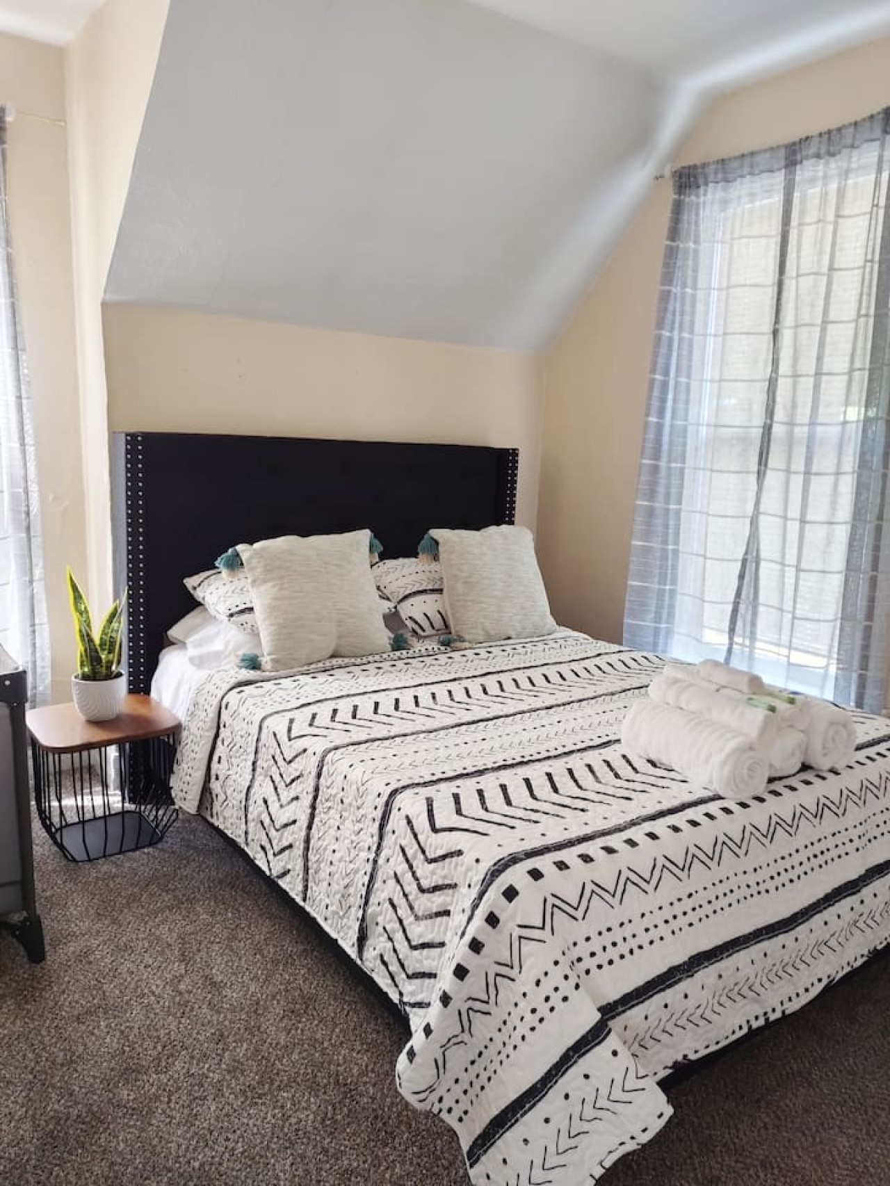 #1 Bedroom: A queen bed with a dresser and tv (Hulu, Disney, ESPN)