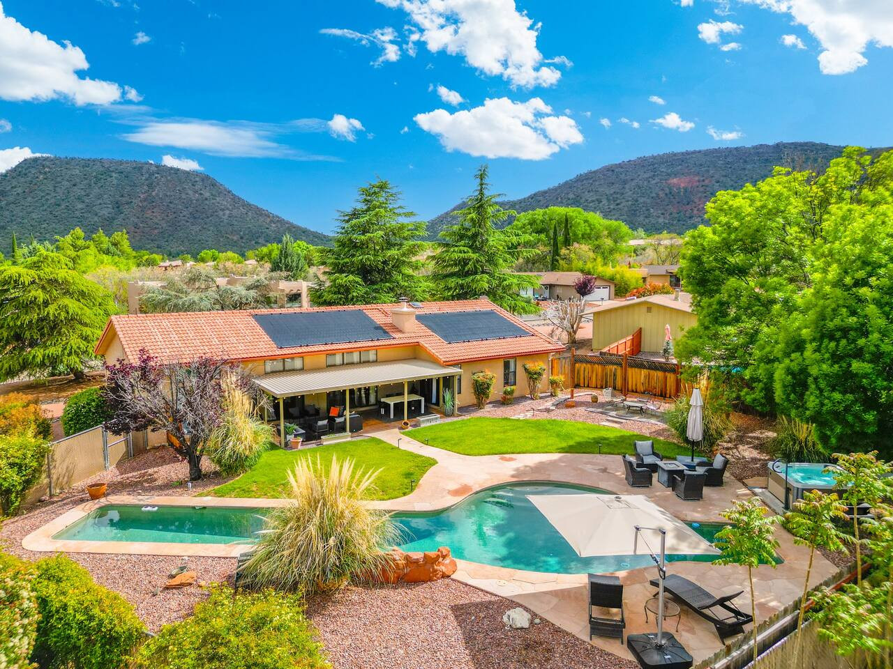 Family-friendly Sedona home with a lush backyard and shaded pool area.