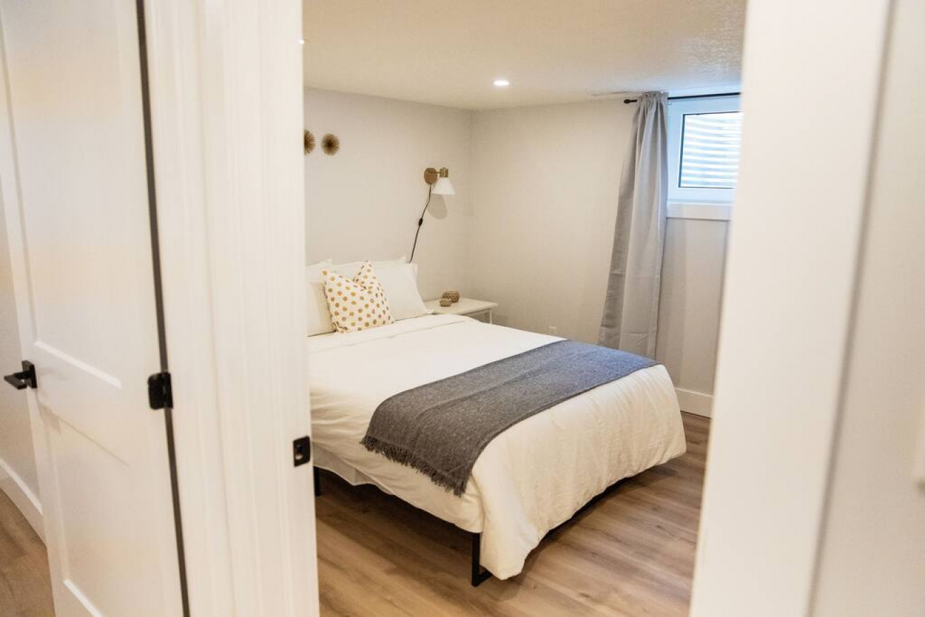 You feel enveloped in comfort as you relax on the queen bed, surrounded by a room designed for tranquility.