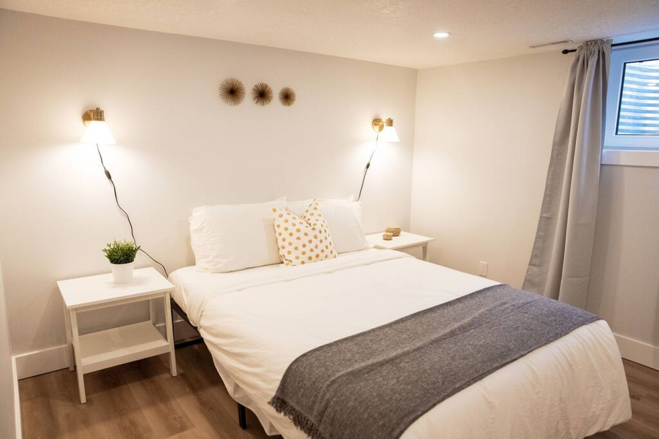 You feel enveloped in comfort as you relax on the queen bed, surrounded by a room designed for tranquility.