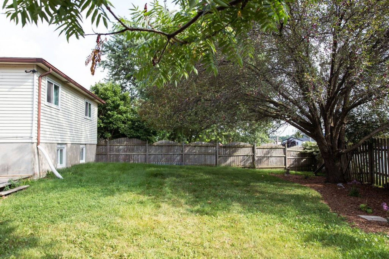 As you approach the house, the inviting entrance and beautiful exterior make you eager to explore what’s inside.