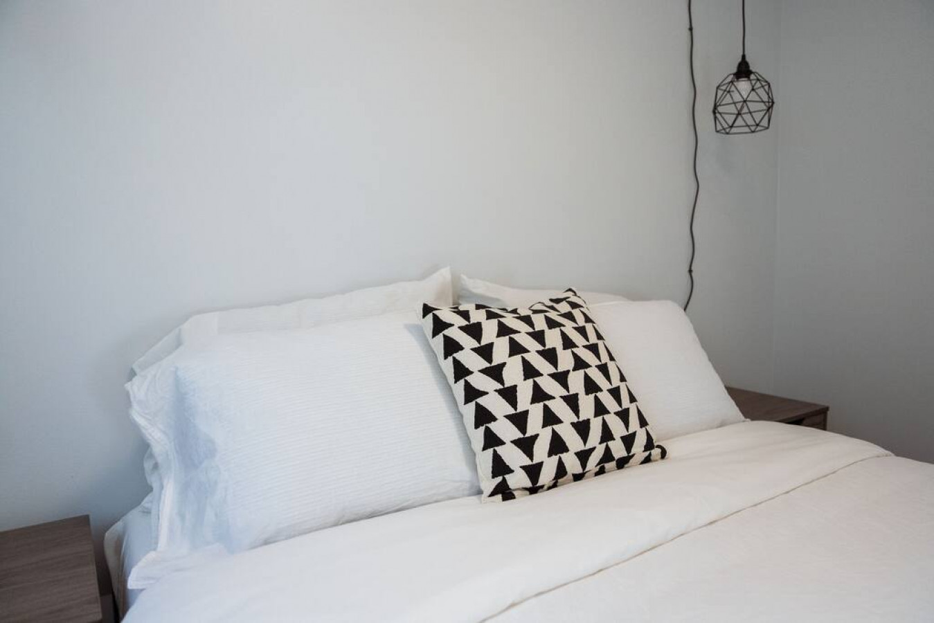 You feel enveloped in comfort as you relax on the queen bed, surrounded by a room designed for tranquility.