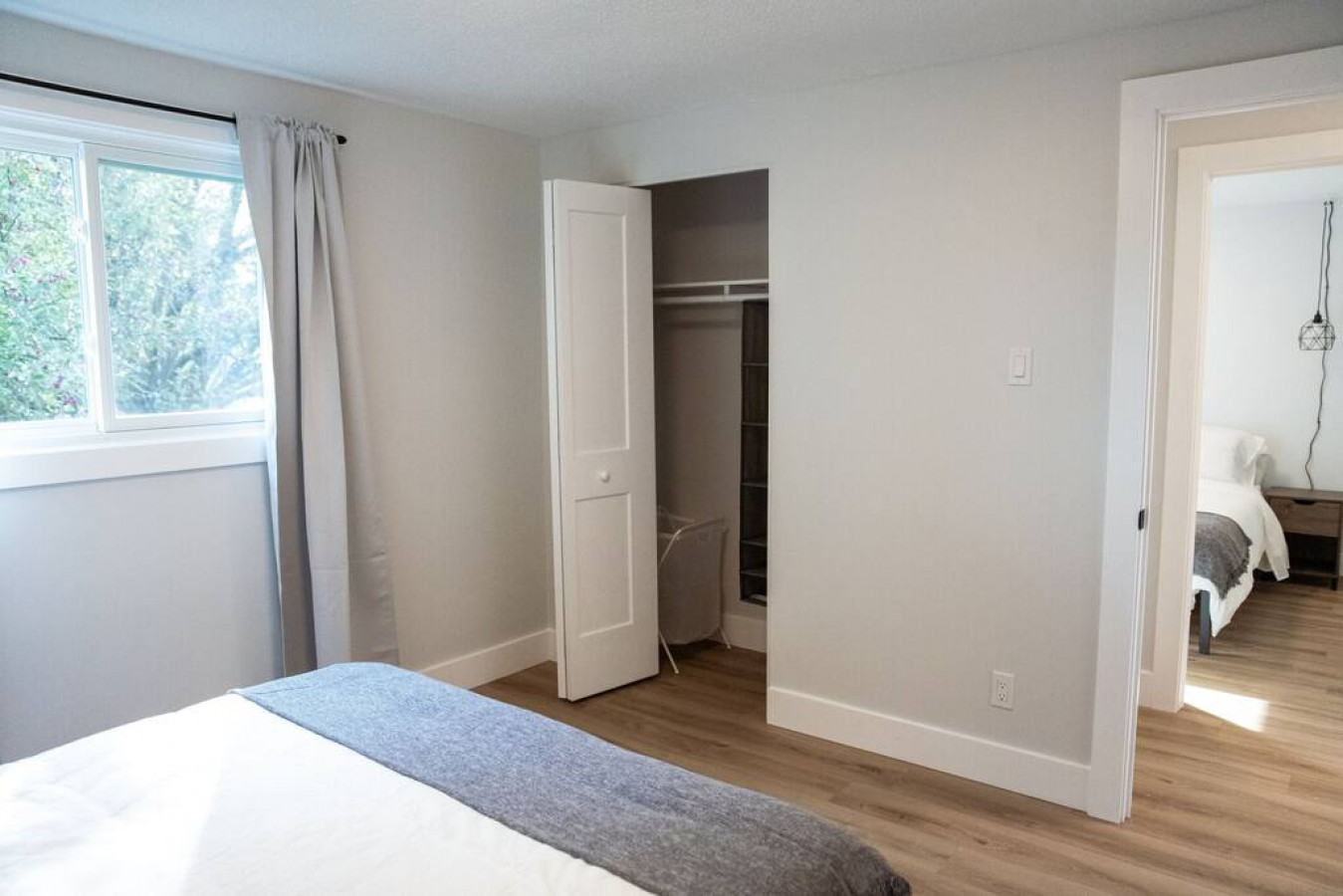Tranquil bedroom with soft bedding and ample closet space, designed to ensure a restful night's sleep.