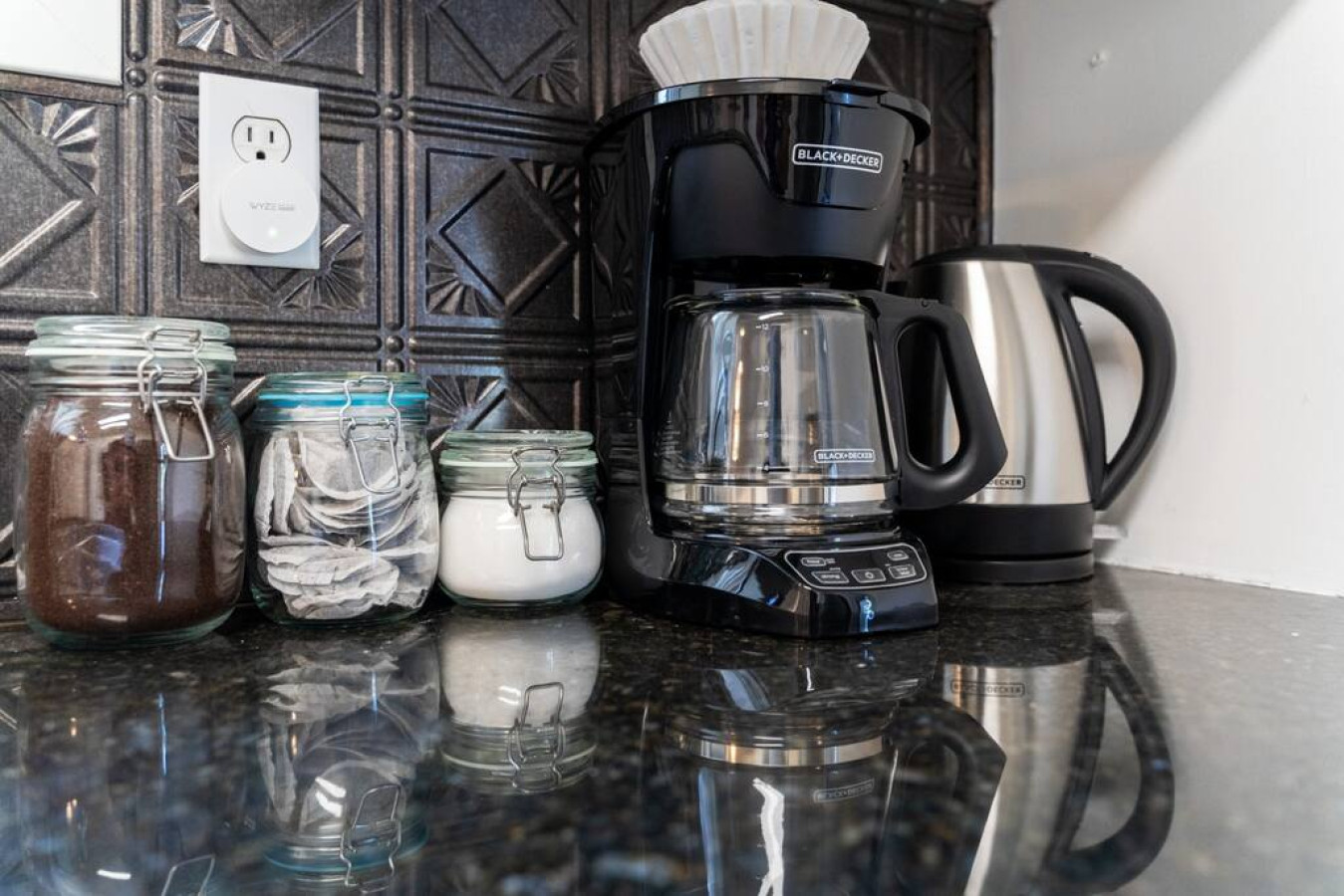 As you open the kitchen, you discover an assortment of coffee pods, and sugar, ensuring you have everything you need for a perfect morning or afternoon pick-me-up.