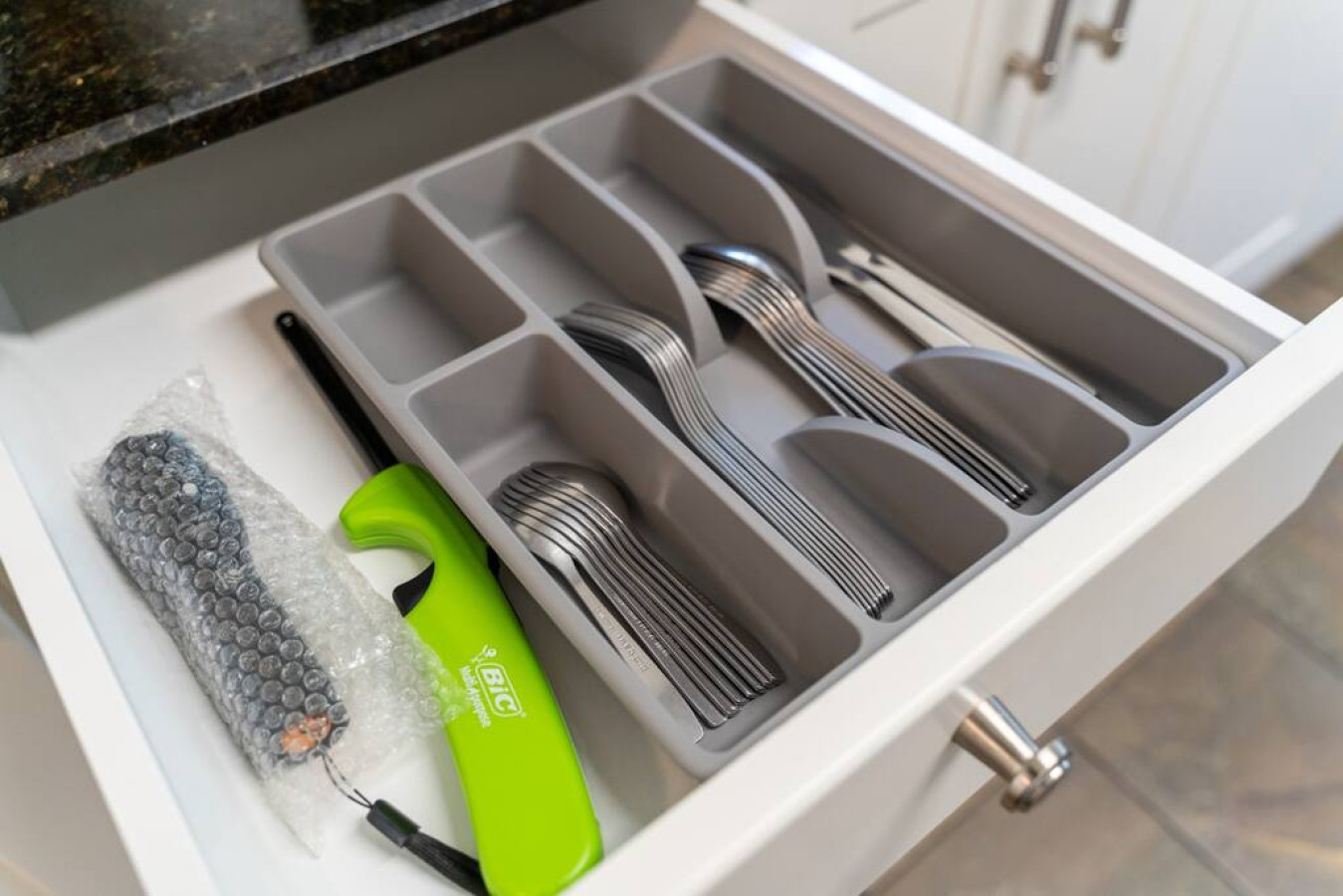 Kitchen utensils with scissors, measuring cups, grater, wine opener, can opener