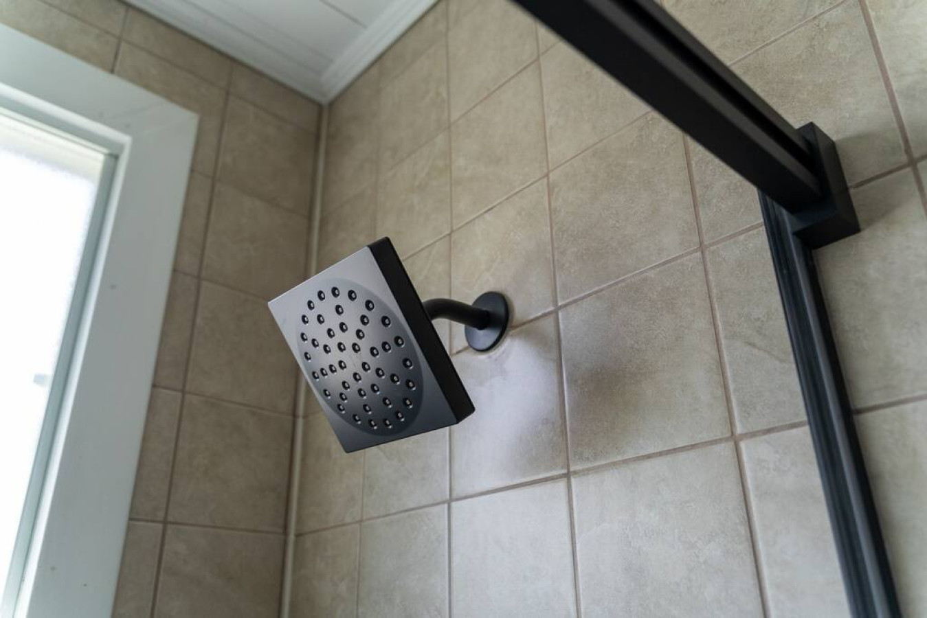 Immaculate bathroom featuring a spacious shower, fresh towels, and complimentary toiletries for a spa-like experience.