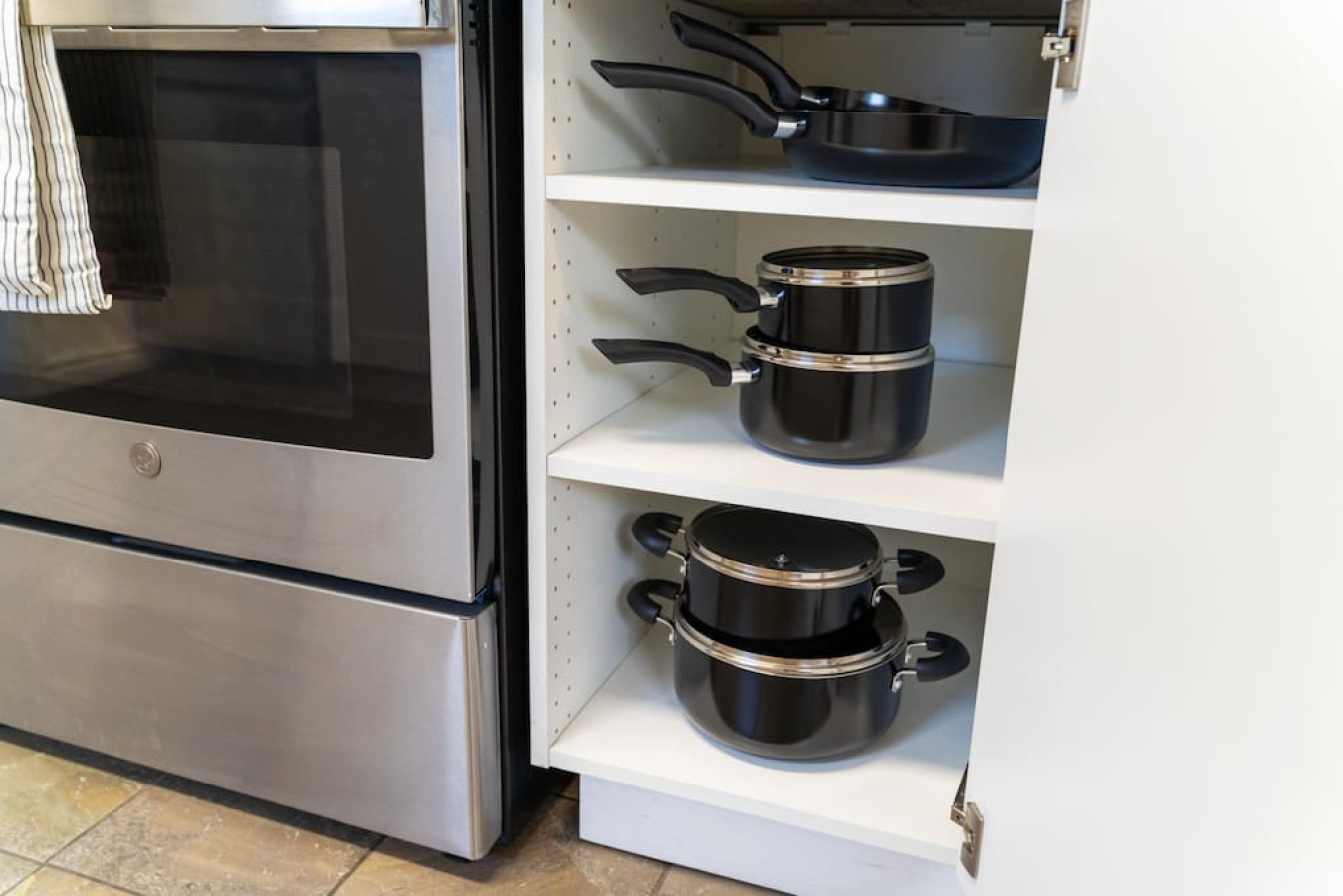 Kitchen cabinets stocked with cooking wares, glassware and silverwares, ideal for mixing up your favorite meals and drinks during your stay.