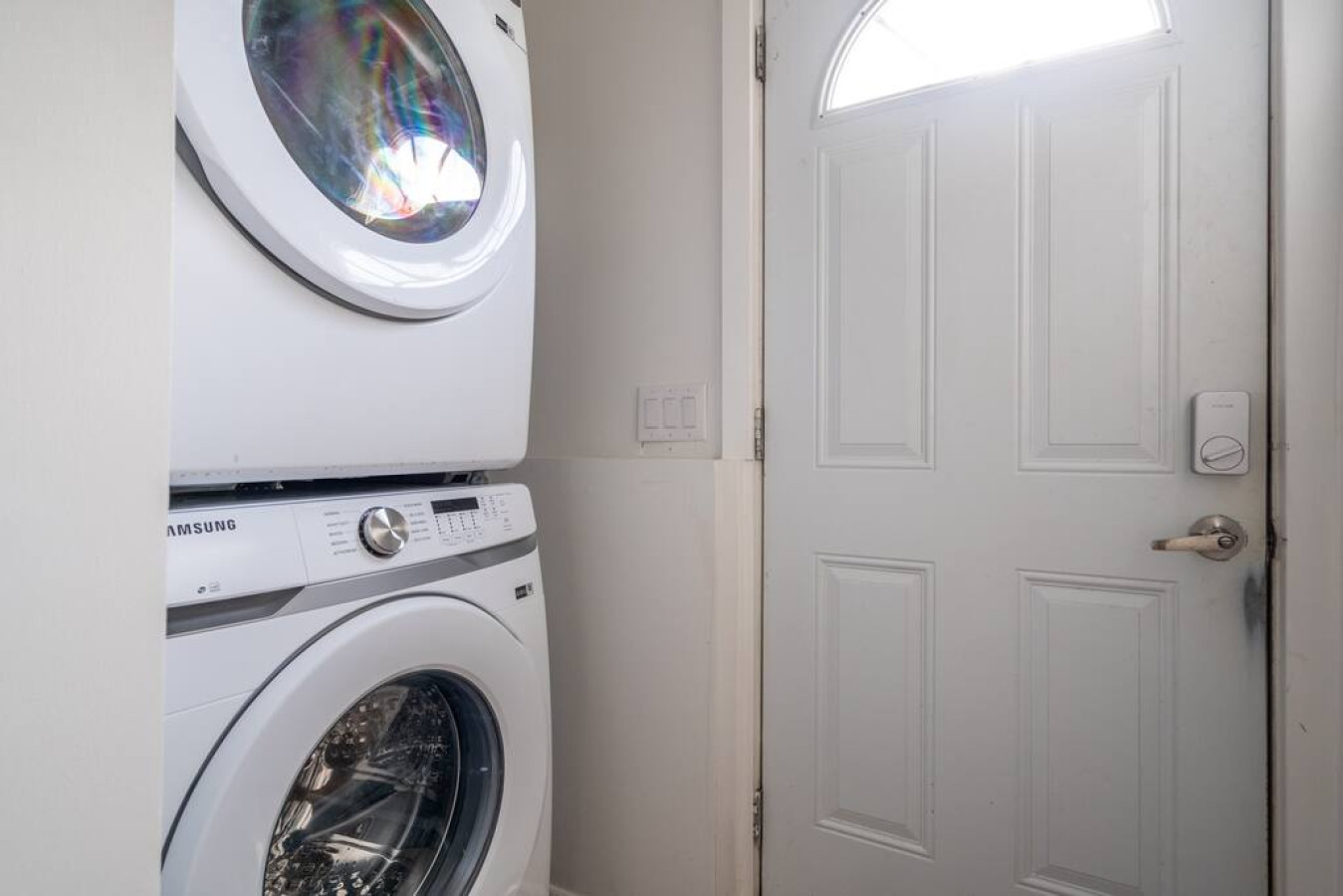 As you step into the laundry room, the modern appliances and ample storage space make it easy to keep things tidy.