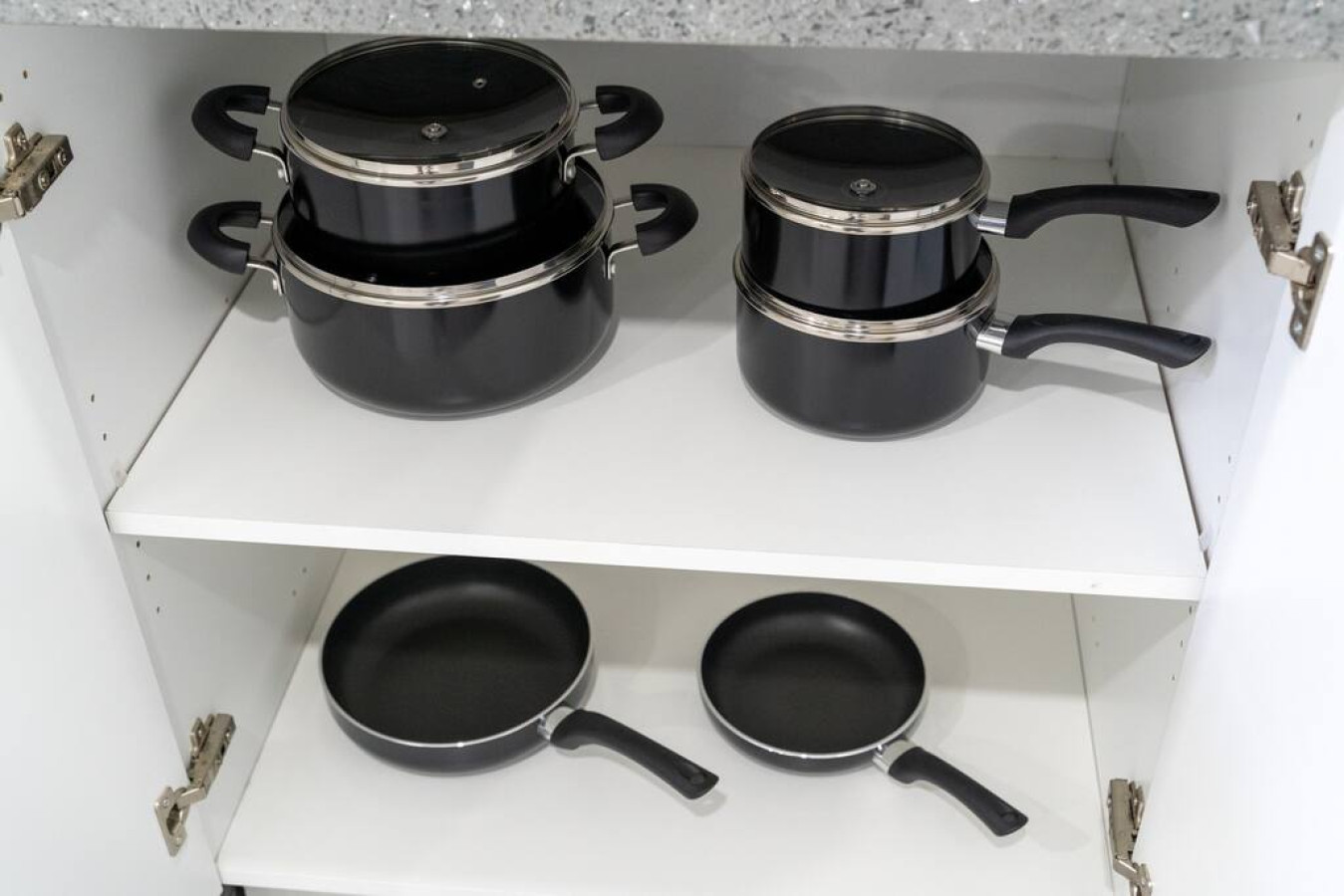Kitchen cabinets stocked with cooking wares, glassware and silverwares, ideal for mixing up your favorite meals and drinks during your stay.
