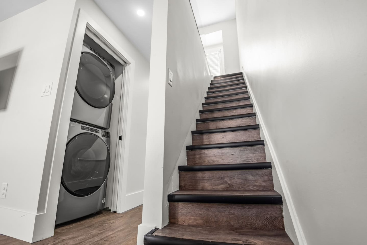 The staircase is a focal point of the home, with its graceful lines and stylish details adding to the overall charm.