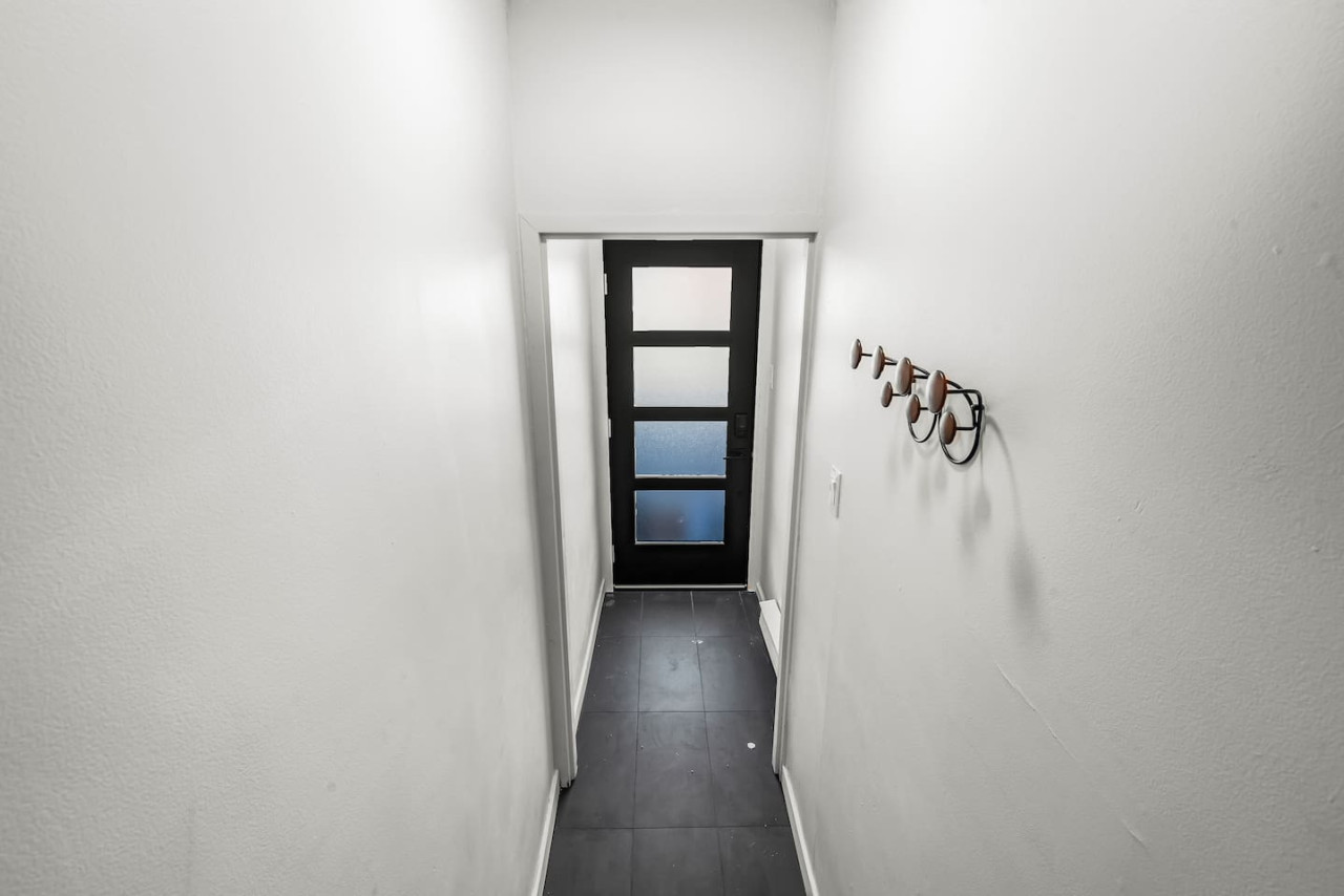 As you approach the house, the inviting entrance and beautiful exterior make you eager to explore what’s inside.