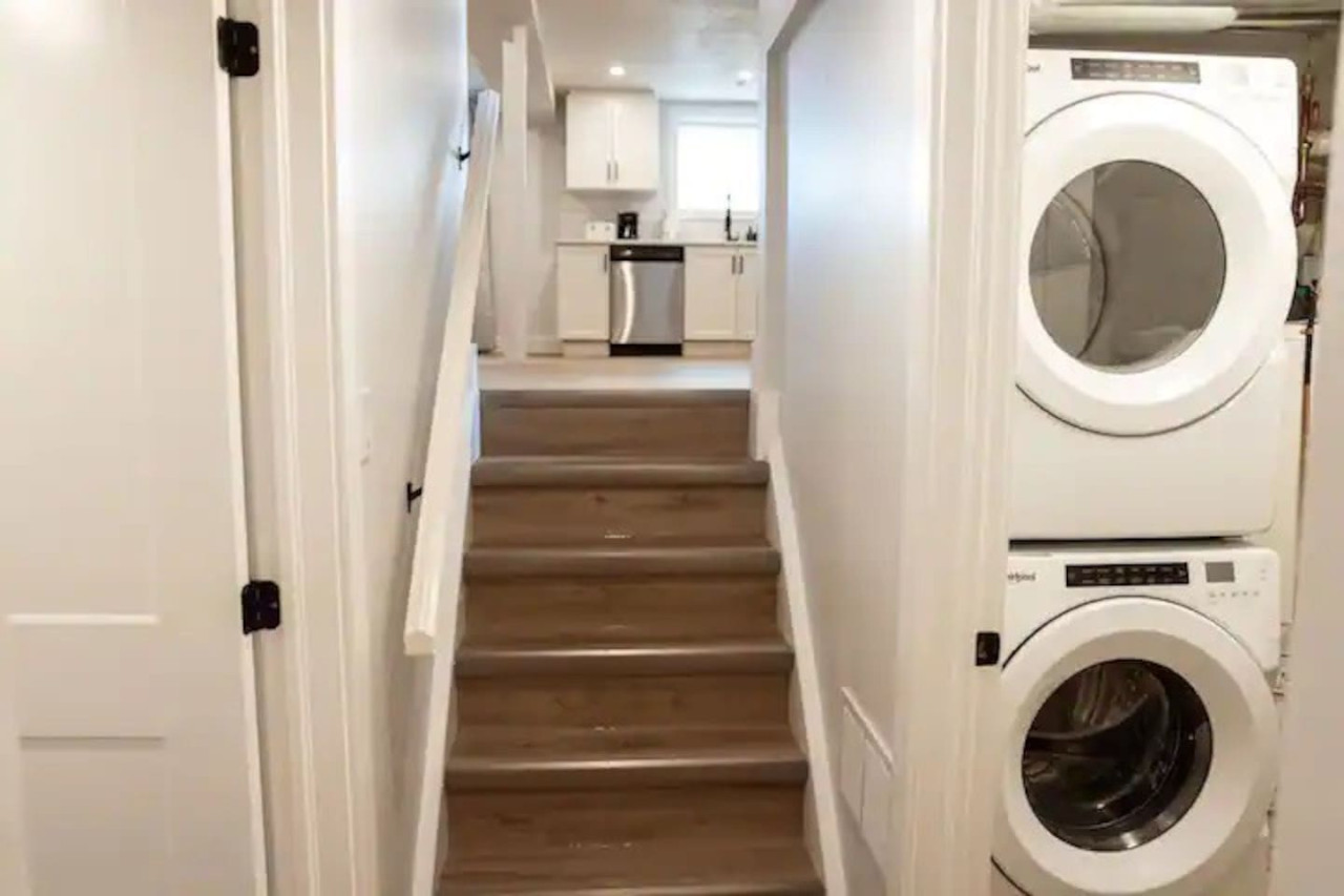 As you step into the laundry room, the modern appliances and ample storage space make it easy to keep things tidy.