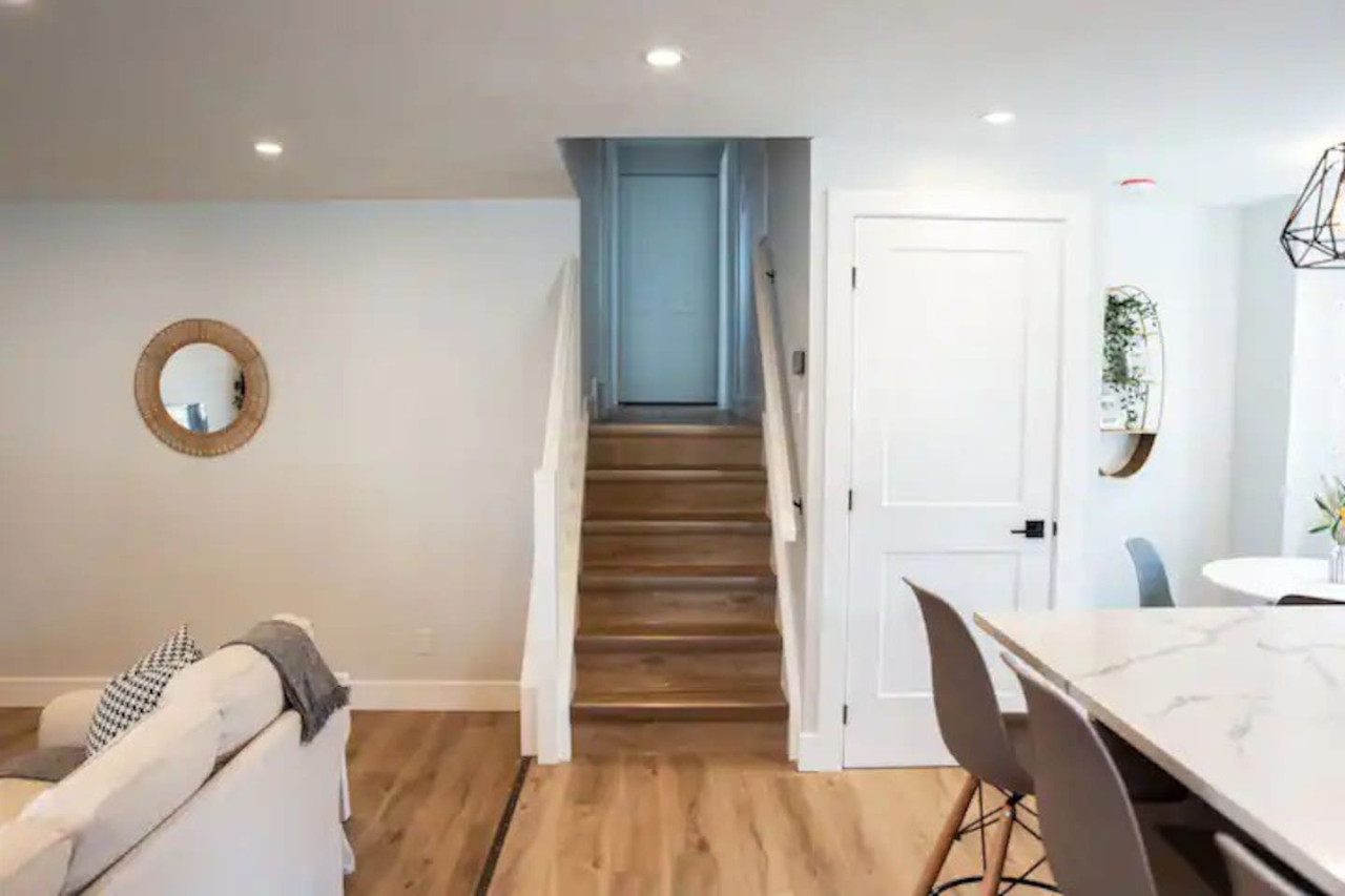 The staircase is a focal point of the home, with its graceful lines and stylish details adding to the overall charm.