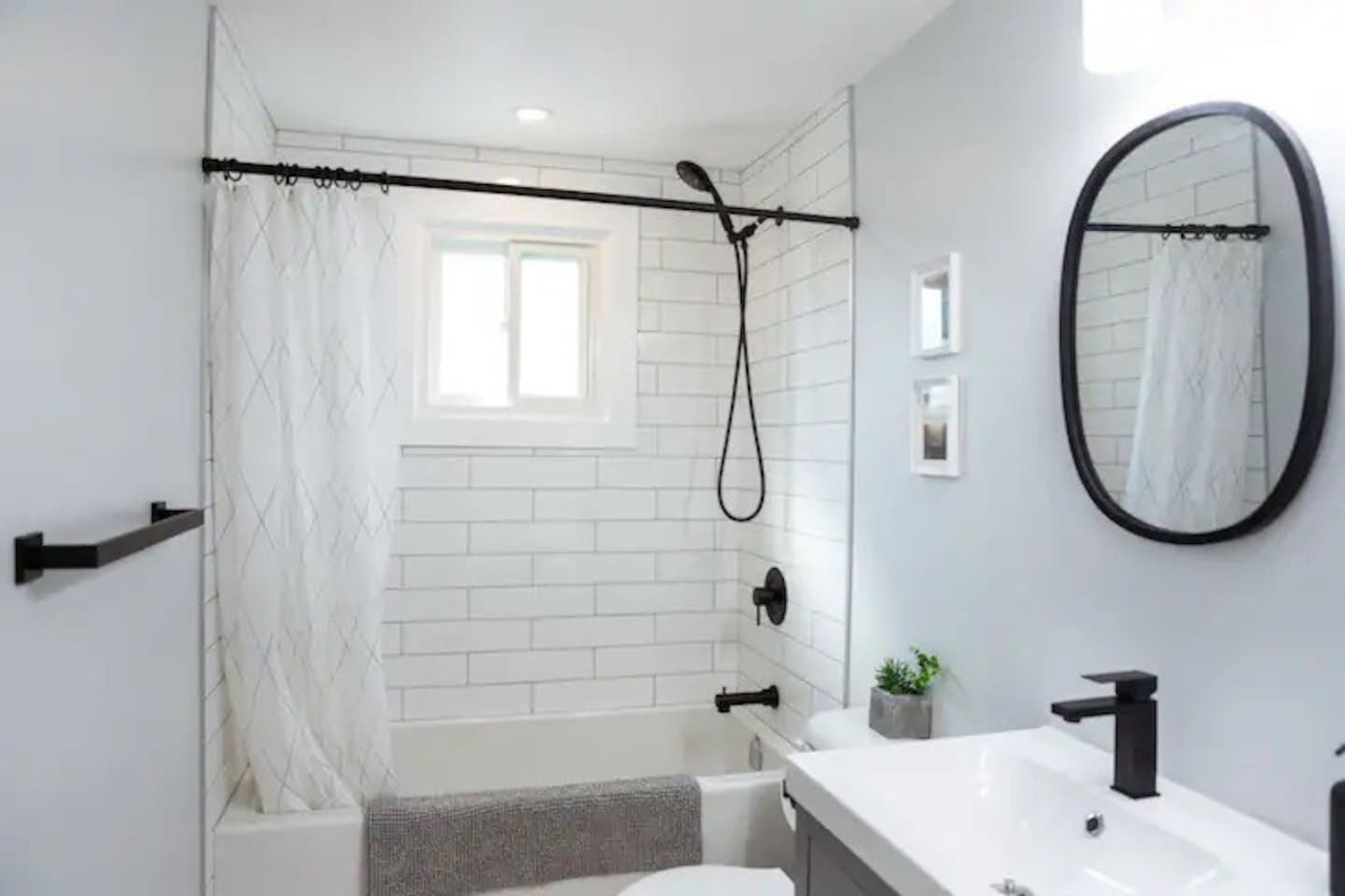 Immaculate bathroom featuring a spacious shower, fresh towels, and complimentary toiletries for a spa-like experience.