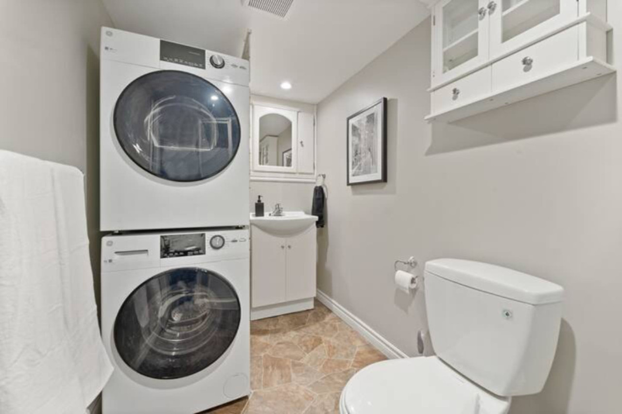 As you step into the laundry room, the modern appliances and ample storage space make it easy to keep things tidy.