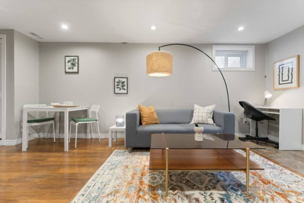 Relax in this warm, inviting space with wooden accents and cozy furnishings. You’ll love unwinding on the plush sofa, enjoying a good book or streaming your favorite shows in a serene atmosphere