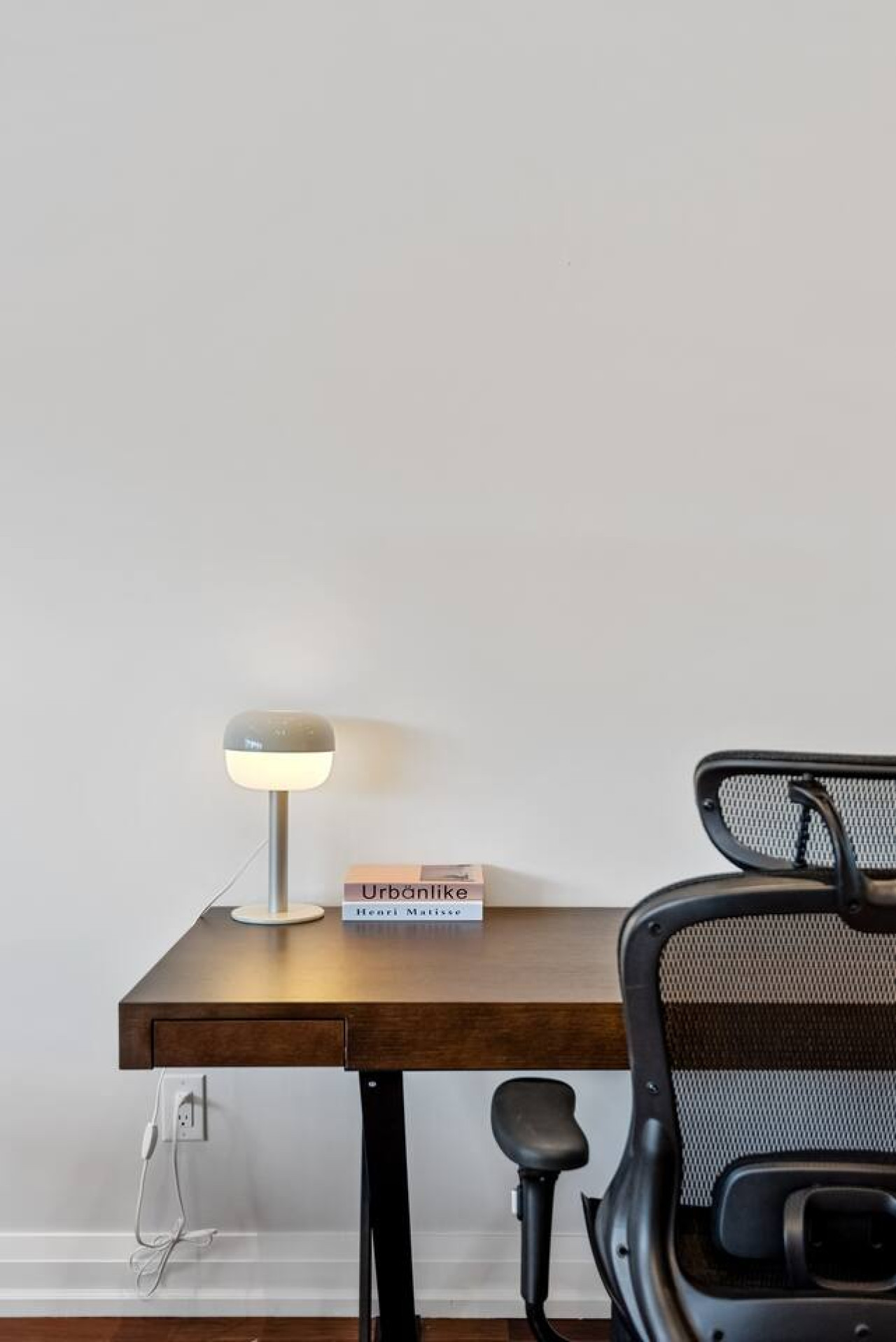 This cozy workspace with warm lighting, and a creative wall display, perfect for productivity.