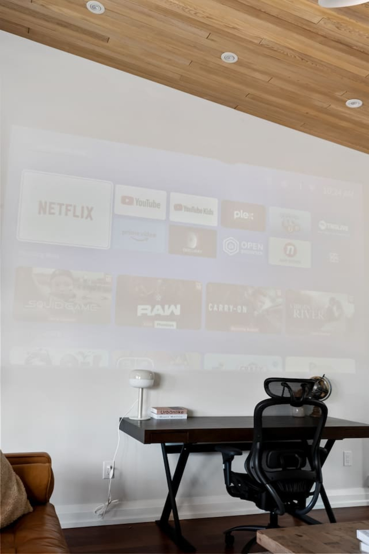 This cozy workspace with warm lighting, and a creative wall display, perfect for productivity.