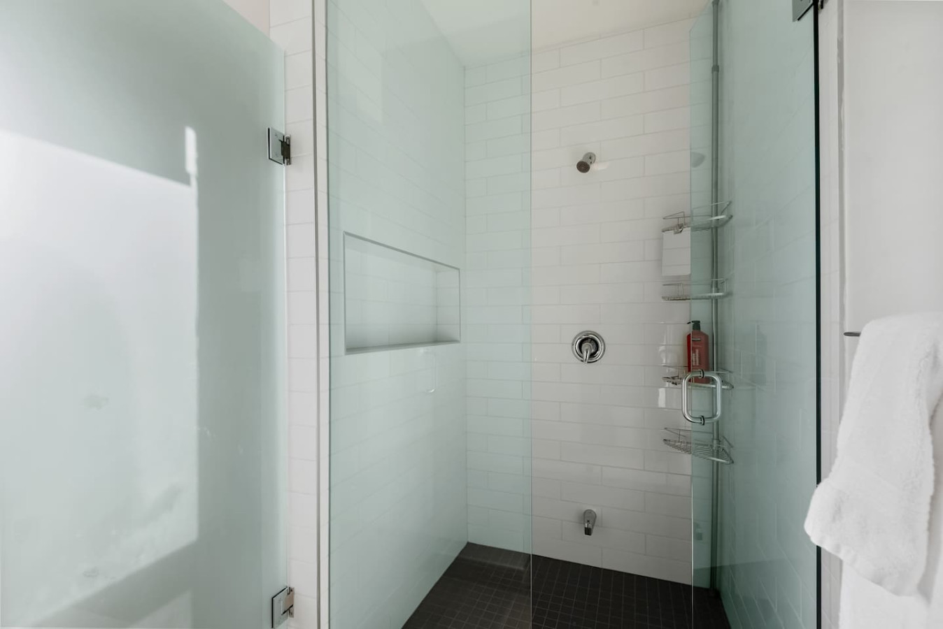 This bright and welcoming bathroom invites you to freshen up in comfort. Enjoy the forest-inspired shower curtain that adds a calming touch to your routine, complemented by the cozy rug underfoot and sparkling clean fixtures.