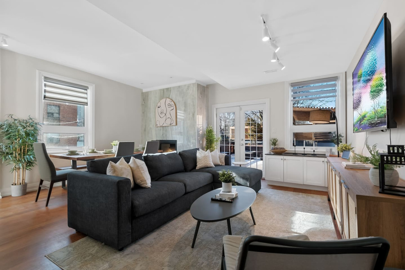 The living room is filled with natural light, creating a bright and welcoming space that invites relaxation.
