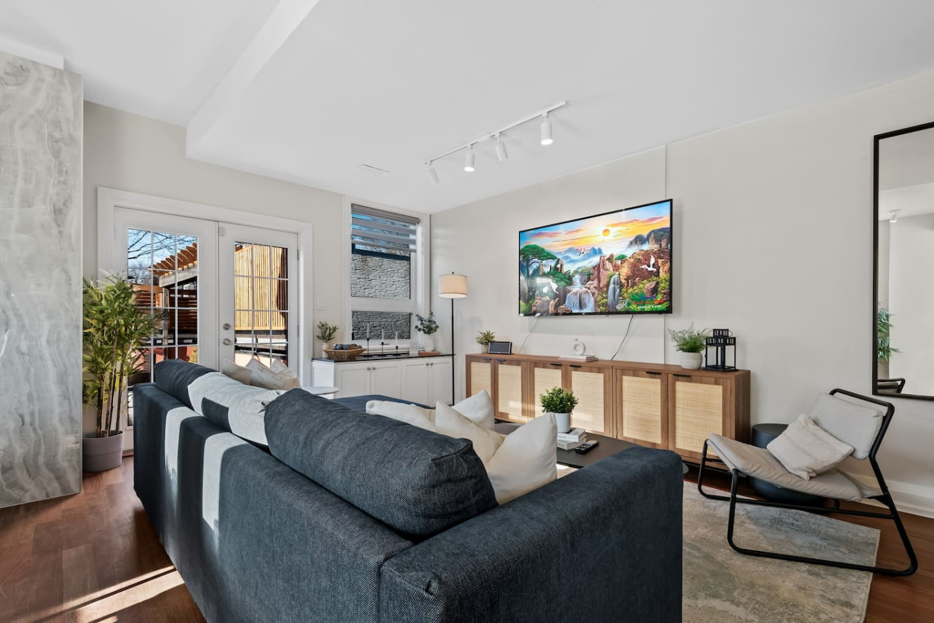 Relax in this warm, inviting space with wooden accents and cozy furnishings. You’ll love unwinding on the plush sofa, enjoying a good book or streaming your favorite shows in a serene atmosphere