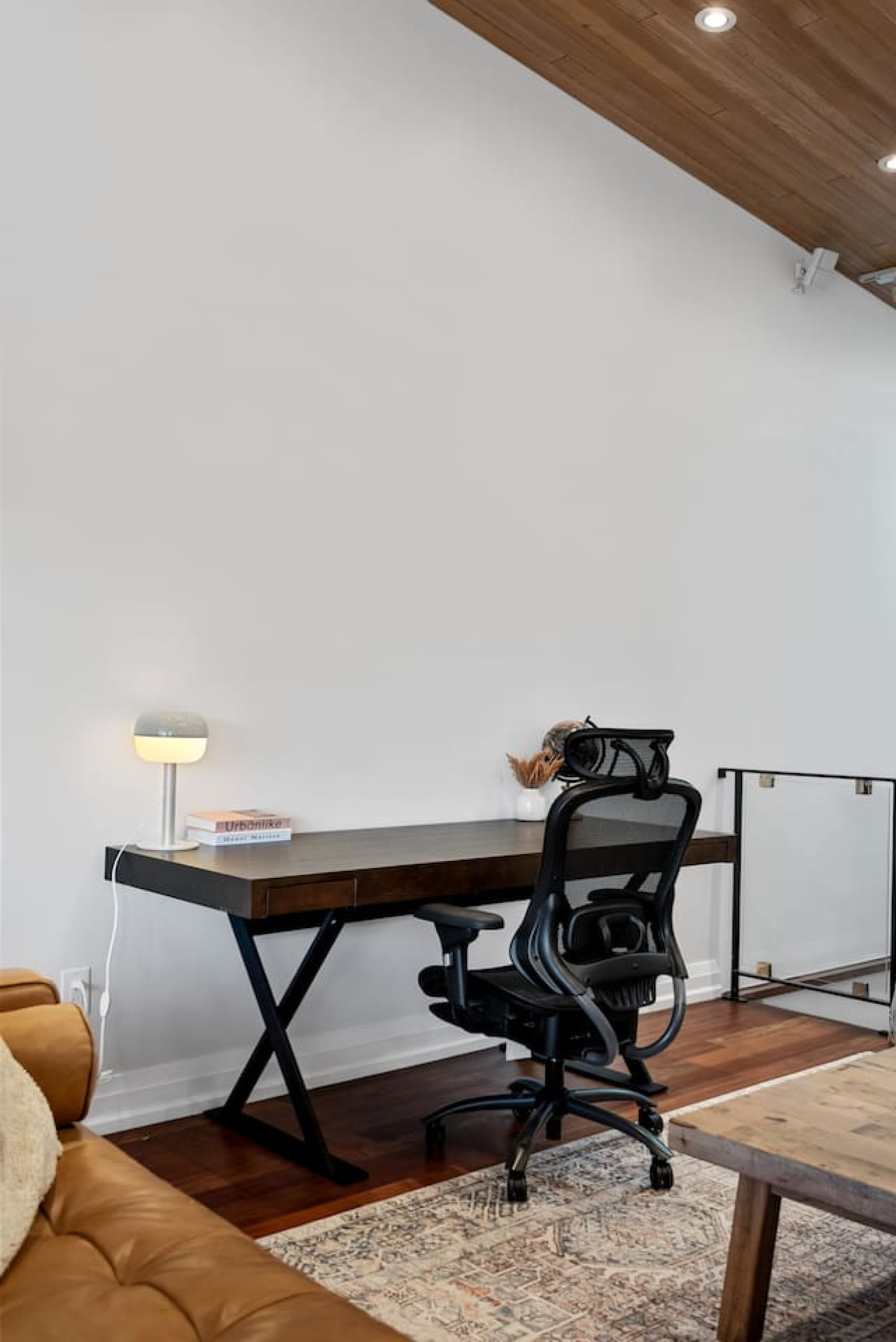 This cozy workspace with warm lighting, and a creative wall display, perfect for productivity.