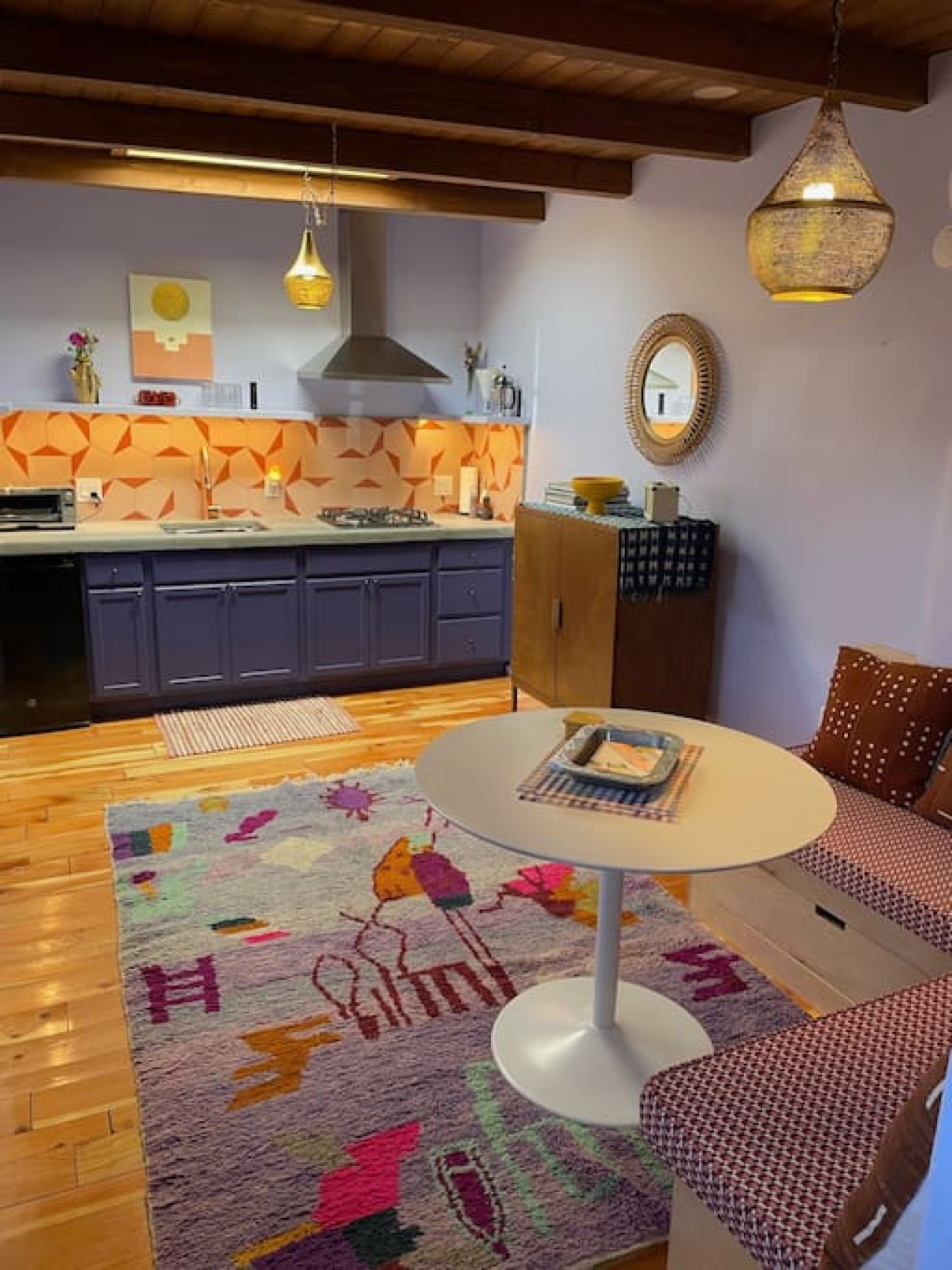 Dining/sitting area with built-in nook. All of our furniture is either upcycled or built and upholstered by local artisans.