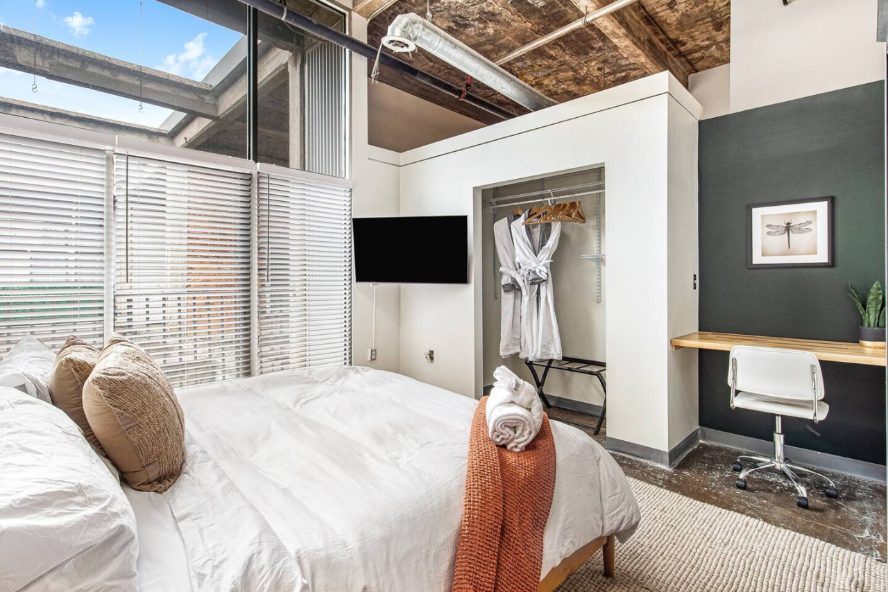 Primary bedroom with King bed, Italian linens, plush robes, 40in TV, & dedicated workspace.